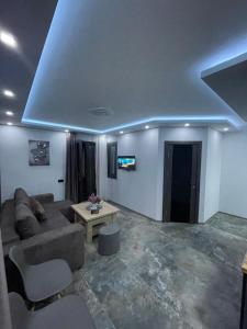 a living room with a couch and a table at Designed Apartment with French Balcony SELF CHECK IN in Yerevan
