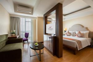 Postel nebo postele na pokoji v ubytování Sahid Raya Hotel & Convention Yogyakarta + 37 fotografií