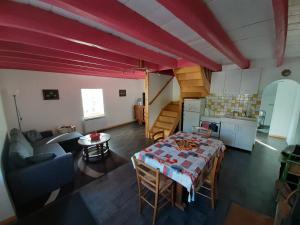 an overhead view of a living room with a table and a kitchen at Gite les Courtaillards in Couches