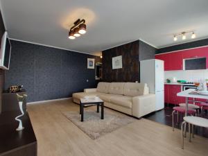 a living room with a couch and a kitchen at Apartment on Internacionalnaya 34 in Bobruisk