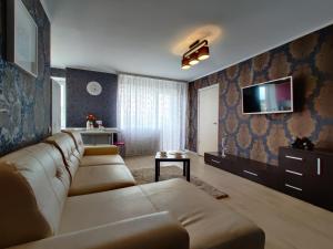 a living room with a couch and a tv at Apartment on Internacionalnaya 34 in Bobruisk