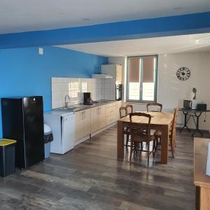 a kitchen with a table and a dining room at gite de l'ornain in Fains-les-Sources