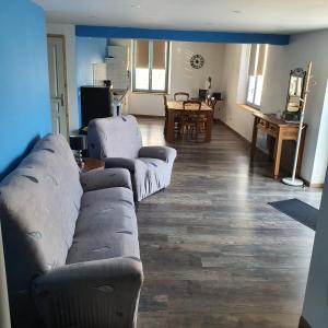 a living room with a couch and a table at gite de l'ornain in Fains-les-Sources