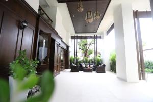 an open hallway with couches and chairs in a building at Double Tree Residence in Chiang Mai