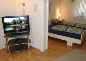 a bedroom with a bed and a television on a table at Ferienwohnung Ilse und Eberhard Tröps in Siegen