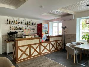 a restaurant with a counter with bottles of wine at Garden Hotel in Kropyvnytskyi