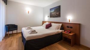 מיטה או מיטות בחדר ב-Residence Pizzo Scalino
