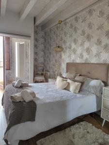 una camera da letto con un grande letto bianco con cuscini bianchi di BELLA VISTA Catedral-Apartamentos Burgos Catedral a Burgos