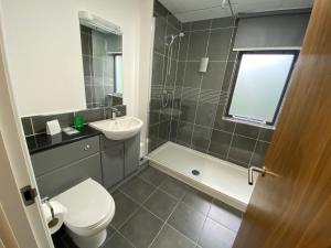 
a bathroom with a toilet a sink and a shower at Ashorne Hill in Leamington Spa
