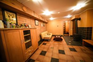 a living room with a couch and a table at LVM tūrisma un atpūtas centrs "Spāre" in Spāre