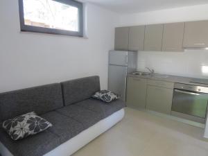 a small kitchen with a couch in a room at Camping Mia Bungalow & Mobile Home in Biograd na Moru