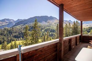 a room with a balcony with a view of the mountains at Miraflor Angela by Arosa Holiday in Arosa