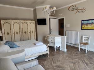 a bedroom with a bed and a dresser and a chair at Chez Tata' - Scé Tatà in Rossano Stazione