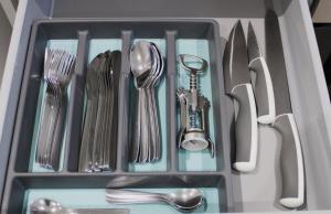 a drawer filled with utensils and silverware at Didcot- Private Flat with Garden & Parking 04 in Didcot