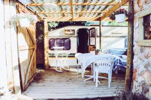 a table and chairs on a porch with an rv at Happy Van in Scarborough