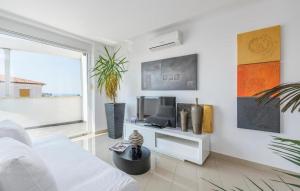 a white living room with a white couch and a tv at Apartment Anna in Novigrad Istria
