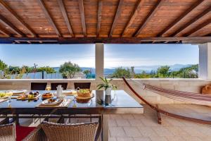 ŽrnovnicaにあるVilla Runjeのパティオ(テーブル、椅子、ハンモック付)