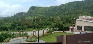a house with a view of a mountain at Akshaya Villa in Lonavala