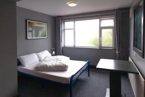 A bed or beds in a room at The Burren Hostel - Sleepzone