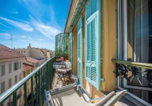 a balcony with a chair on a balcony at LE FOCH AP4244 By Riviera Holiday Homes in Nice