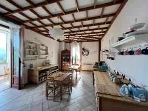 a kitchen with a table and chairs in a room at Frankie’s House in Ghiffa