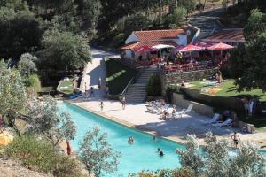 a group of people in a pool at a resort at Casa da Ti Emília in Cardigos