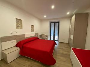 Roseto ValfortoreにあるB&B Il Giardino Nascostoの赤いベッド1台(赤い毛布付)が備わるベッドルーム1室が備わります。