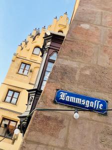 a street sign in front of a brick building at Burghotel Nürnberg in Nuremberg