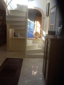 un couloir avec des escaliers blancs et un escalier dans l'établissement Chambre hôtes Wagram, à Ajaccio