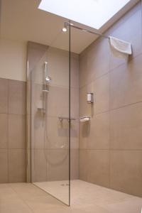a shower with a glass door in a bathroom at Motel Lohwasser in Lichtenau
