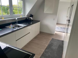 a kitchen with a sink and a counter top at Ferienwohnung Falkenfeld in Lübeck