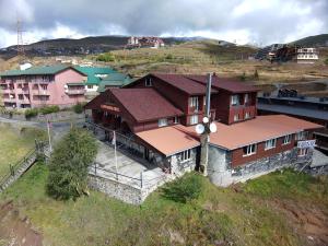 a building with a clock on it on a hill at Gudauri Hut Hotel in Gudauri