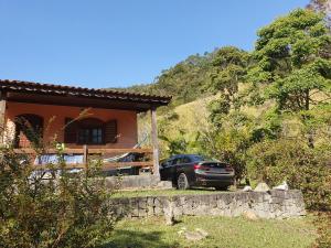 a car parked in front of a house at Eco Pousada Eldorado Lumiar in Lumiar