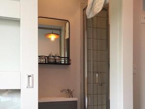 a bathroom with a sink and a mirror and a shower at The Broadmead in Falmouth