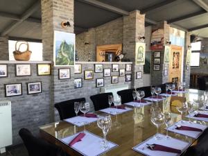 a dining room with a long table with wine glasses at Home of the Great Wall in Huairou