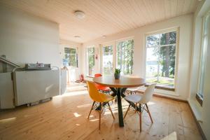 a dining room with a table and chairs at LVM tūrisma un atpūtas centrs "Spāre" in Spāre