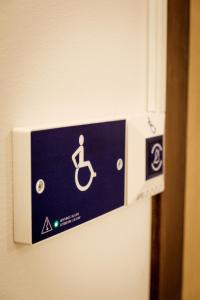 a blue and white sign on a bathroom wall at LVM tūrisma un atpūtas centrs "Spāre" in Spāre