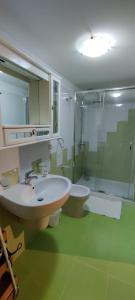 a bathroom with a sink and a shower and a toilet at Modern Apt REVENTINO - Le Lincelle, Lamezia in SantʼEufemia Lamezia