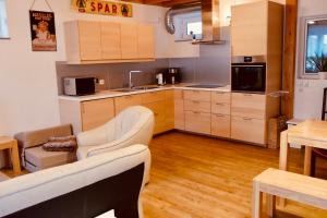 a kitchen with a couch and a table in a room at FerienTurm in Niederstetten