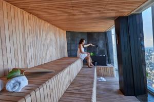 a woman sitting in a sauna on a building at Shangri-La The Shard, London in London