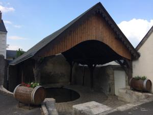 a building with a large opening with two barrels at Gîtes de Loire in Mosnes