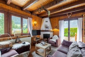 a living room with a couch and a table at Chalet ChouChou in Morgins