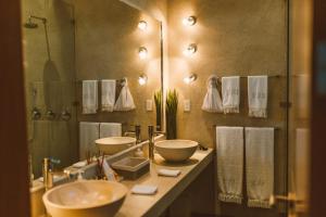 a bathroom with two sinks and a mirror at Jashita Hotel in Tulum