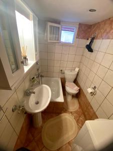 uma casa de banho com um lavatório e um WC em Olympus Aroma em Litochoro