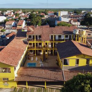 an aerial view of a town with yellow houses at Praia Sol Pousada in Prado