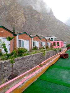 a row of houses in front of a mountain at Hidden valley Lake Resort in Gircha