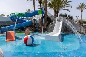 a boy is playing in a water park at Gloria Palace San Agustín Thalasso & Hotel in San Agustin