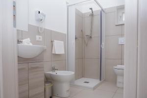 a bathroom with a shower and a sink and a toilet at Malù B&B in Cimitile