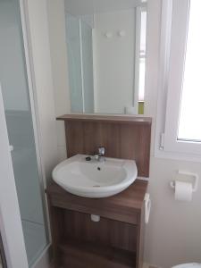 a bathroom with a sink and a mirror at Camping Mia Bungalow & Mobile Home in Biograd na Moru