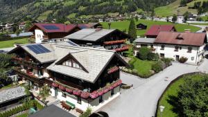 an aerial view of a house with solar panels on the roof at Gästehaus Schernthaner in Dorfgastein